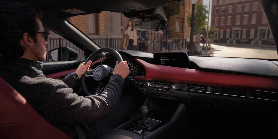 A man driving the 2023 Mazda3 Hatchback